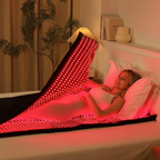 Infrared Therapy Blanket emitting red light, used by a woman lying in bed for muscle recovery and improved circulation at home.
